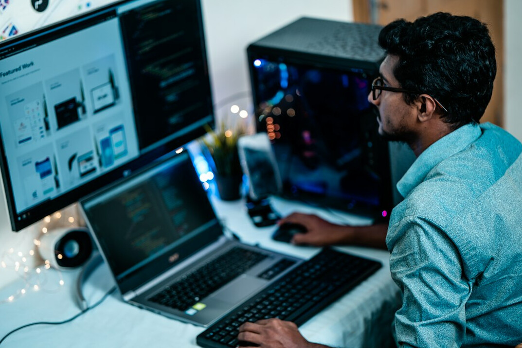 programming student coding on laptop