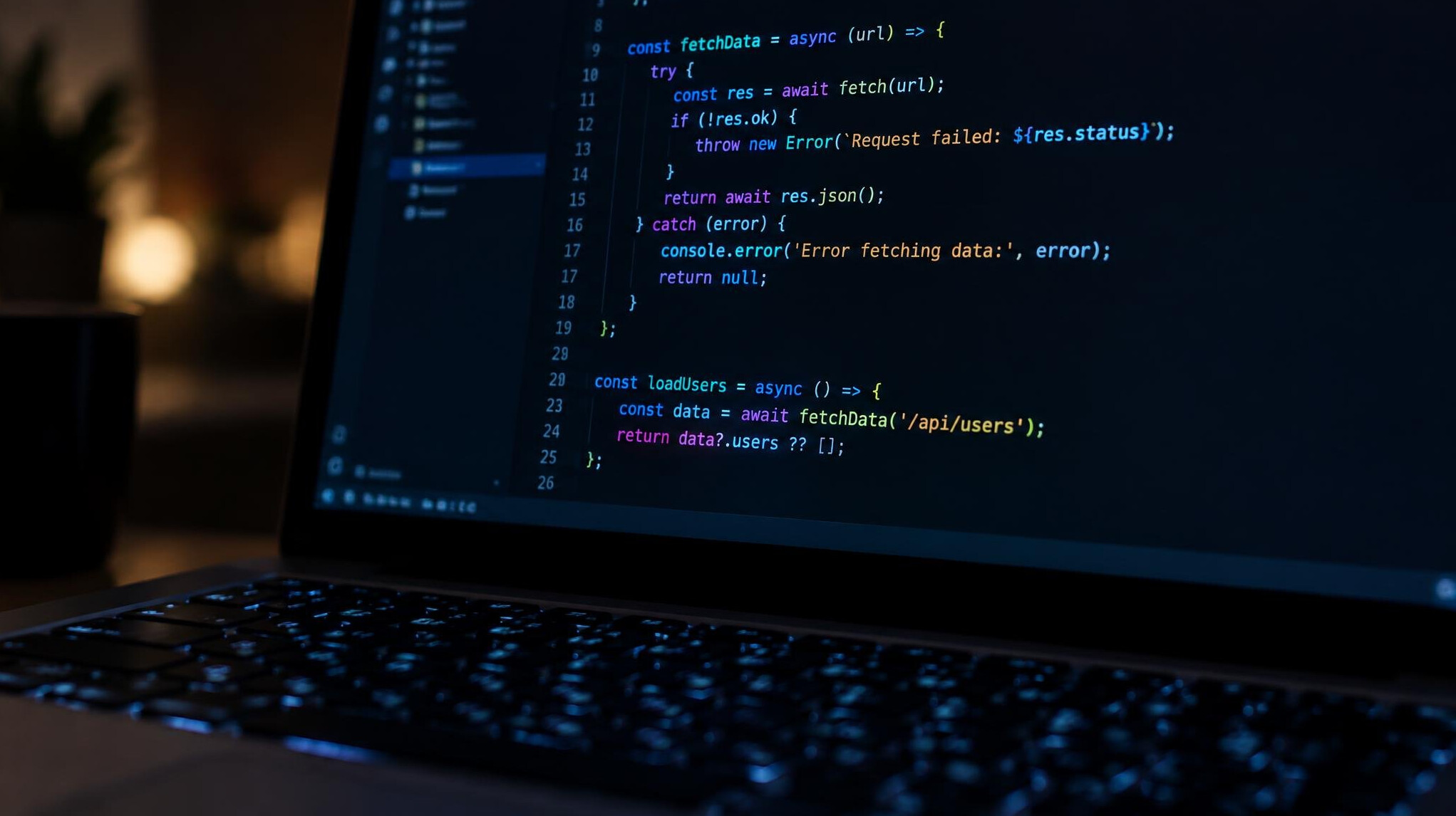 Close-up of a laptop screen displaying colorful lines of programming code